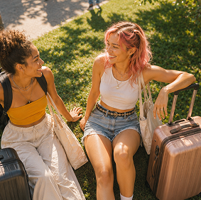 A student with a suitcase in a dorm room